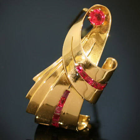 Bow shaped golden retro brooch with rubies