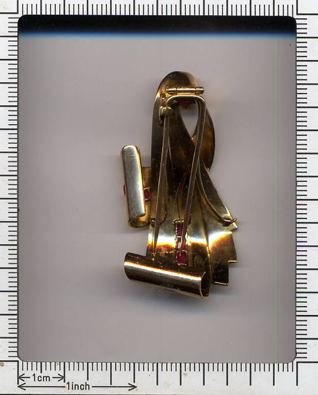 Bow shaped golden retro brooch with rubies