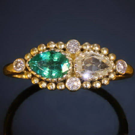 Elegant vintage engagement ring with pear shape diamond and emerald