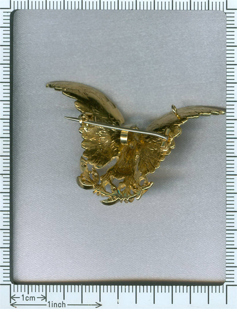 Estate brooch, eagle with spread wings holding a natural colored diamond in beak
