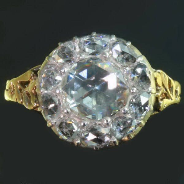 Antique engagement ring with big rose cut diamond engird by smaller rose cuts