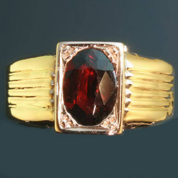 Gold Victorian ring set with garnet and with hidden space that can be closed