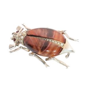 A circa 1880 beetle brooch with reddish tiger’s eye and seed pearls